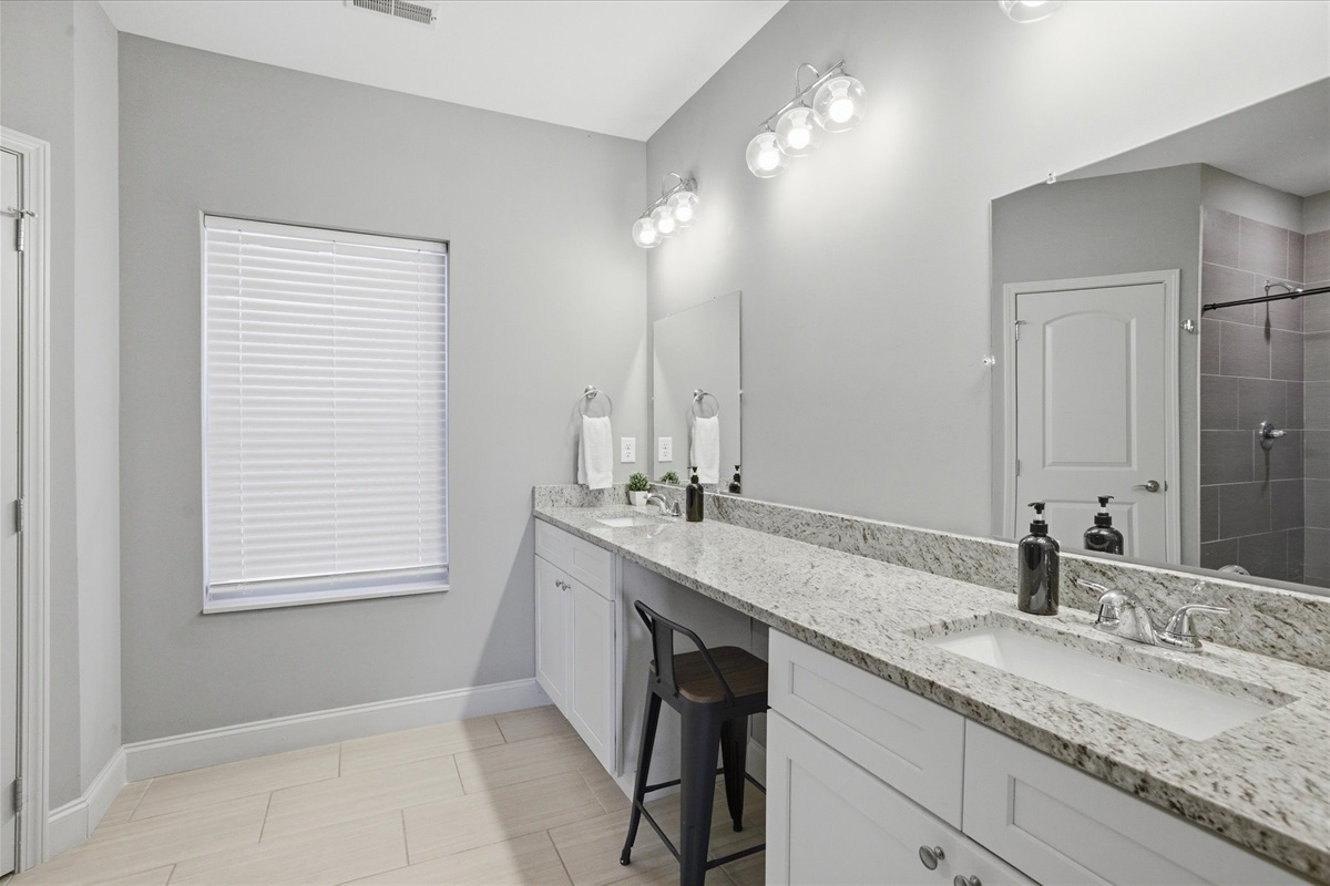 Unit 1’s master bath gives you room to get ready your way—double sinks, clean finishes, and a layout that keeps things calm and easy to move through.