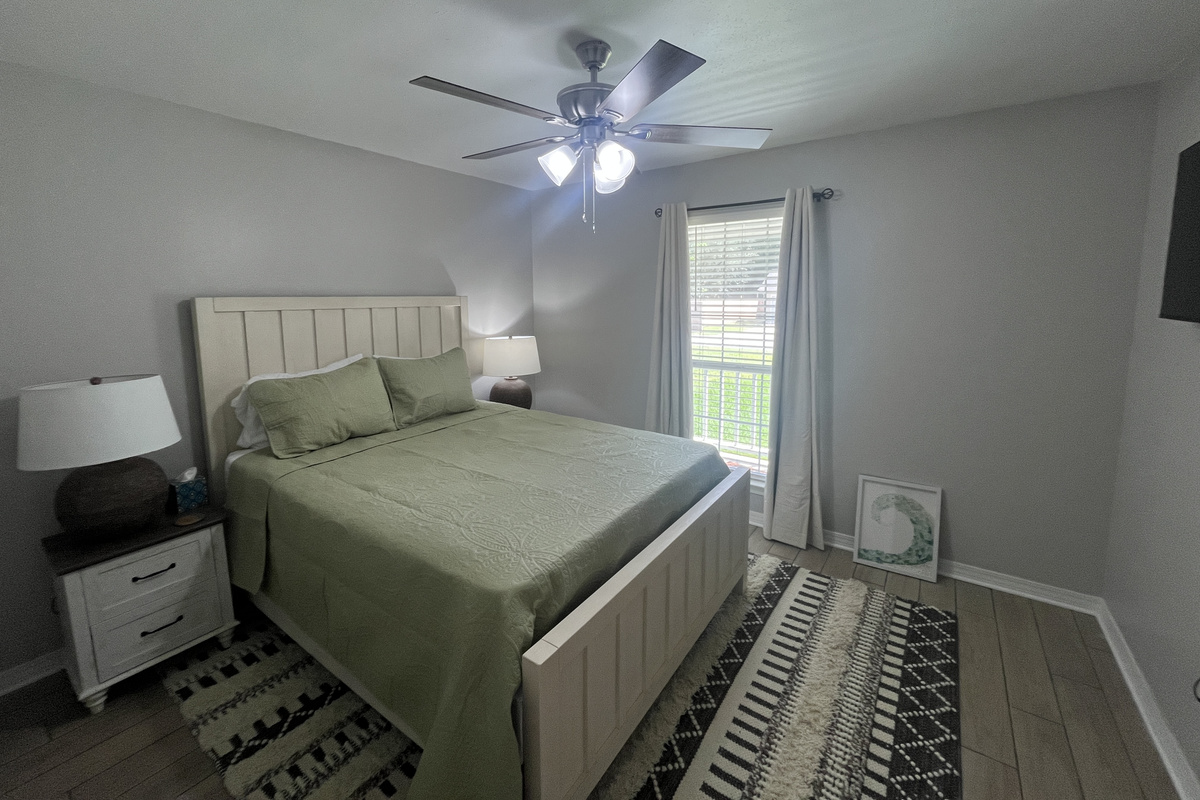 Relaxing queen bedroom with smart tv.