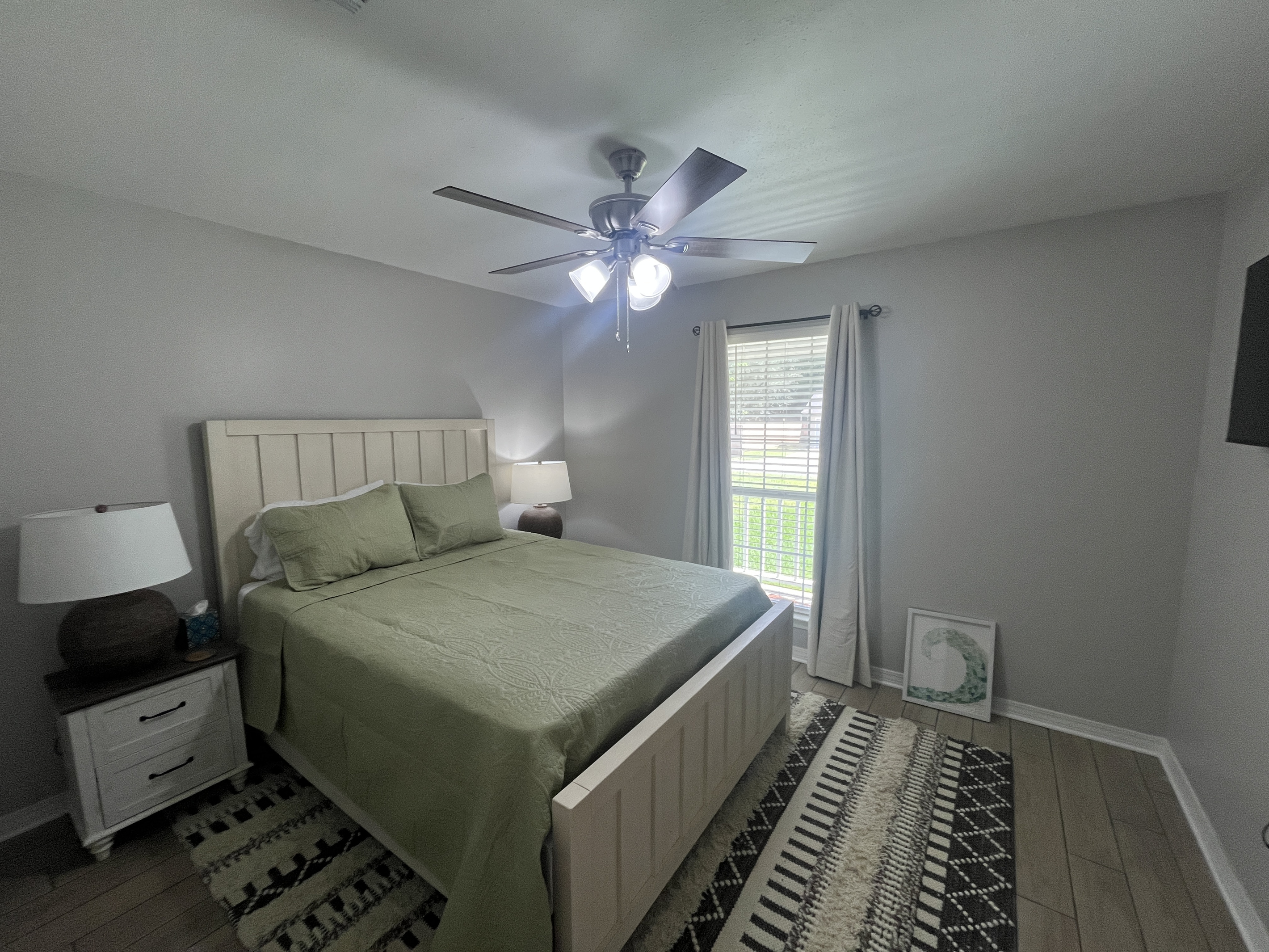Relaxing queen bedroom with smart tv.