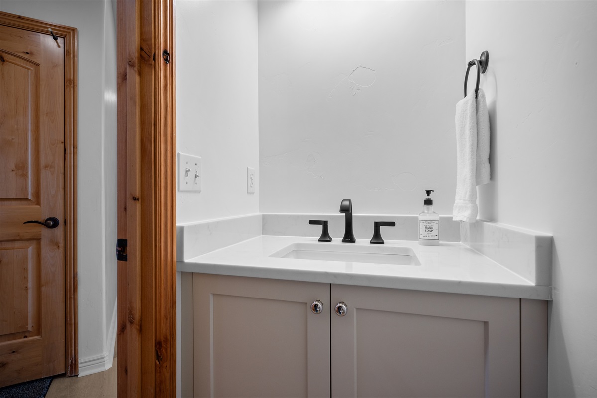 Stylish half bath featuring a modern vanity and sleek fixtures for added comfort and convenience.