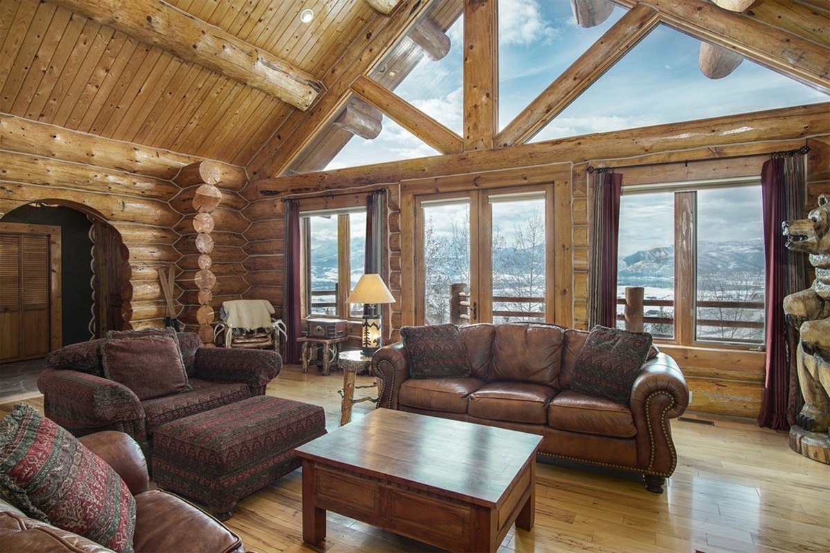Spacious great room with vaulted ceilings, cozy seating, and stunning mountain views
