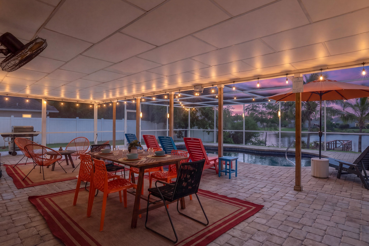 Screened lanai features outdoor dining and colourful seating for relaxed family gatherings