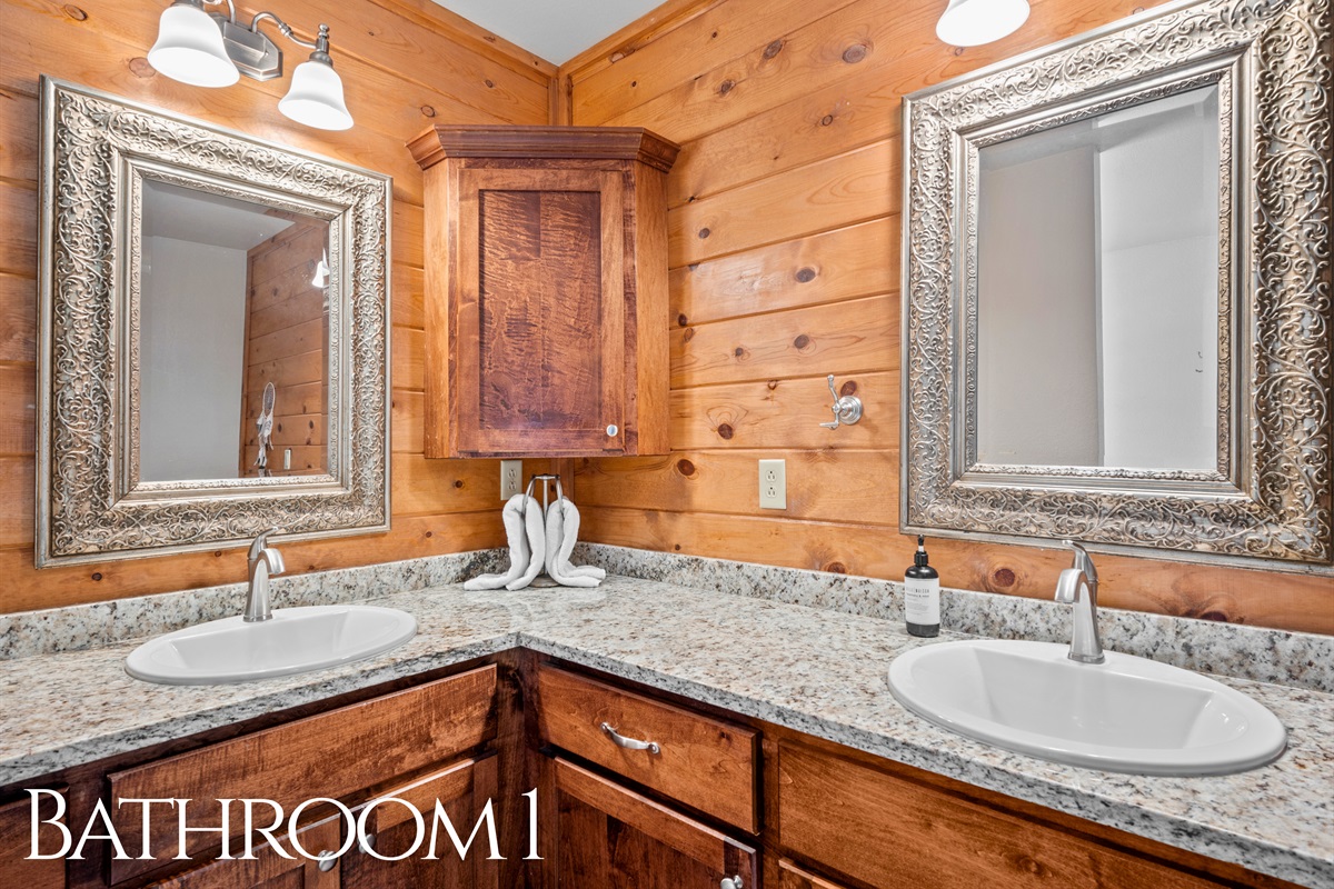 Spacious bathroom with dual sinks and wood detailing throughout.