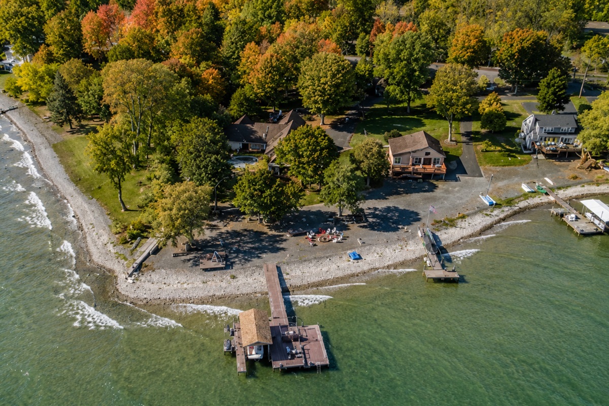 Lakefront escape nestled in fall colors with a private shoreline perfect for morning coffee views. Ideal for guests seeking peaceful Finger Lakes relaxation.