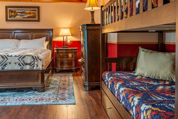 Down stairs bedroom with king size bed and twin over twin bunkbed