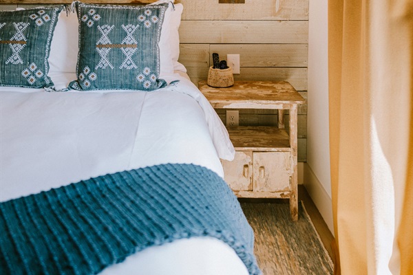 Cutter's Quarters Bedroom #1 &mdash; premium Comphy linens layered with curated modern Western styling at the bedside.