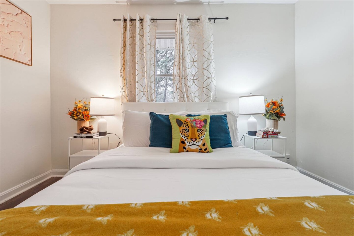 A cozy bedroom with a Queen bed, ceiling fan, TV, bedside lamp, and a spacious closet to keep your belongings organized.
