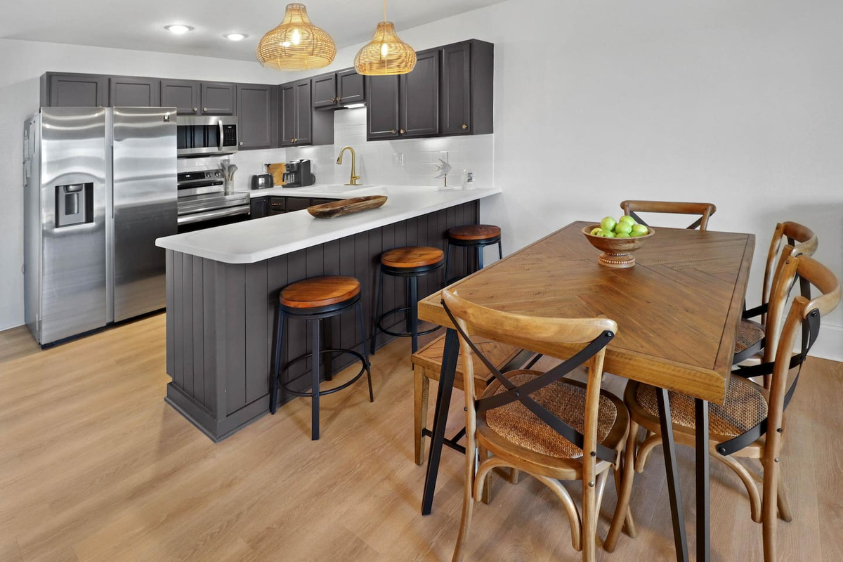 Seat the whole group at the dining table &mdash; it comfortably fits nine, so no one gets stuck at the kitchen counter.