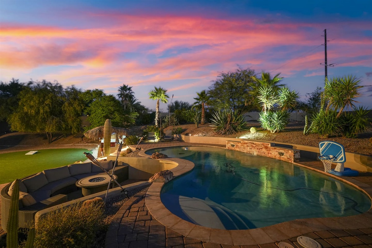 Golden-hour pool scene showcasing the tranquil desert setting and open skies.
