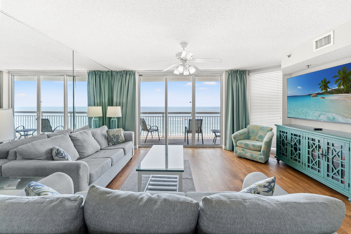 Oceanfront Spacious Living Room with balcony access and large TV