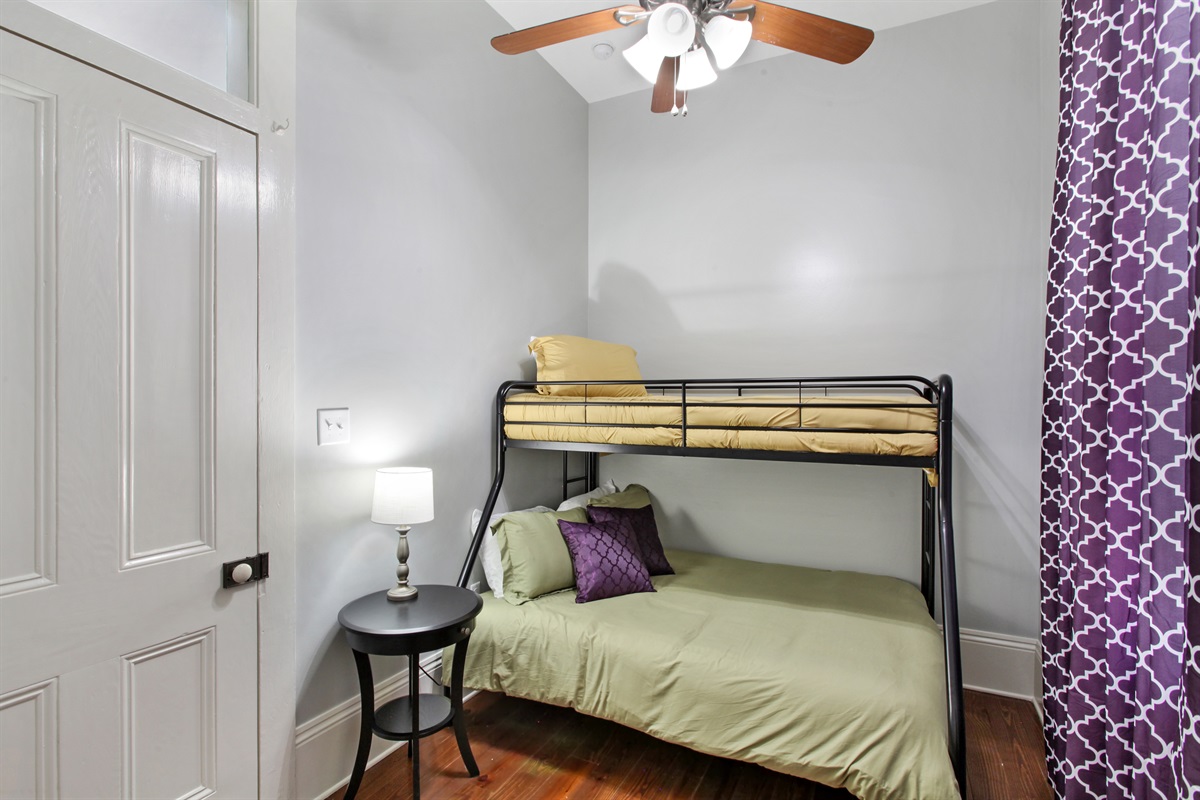 Bedroom 1. 1 full bed. 1 twin bed. Closet. Luggage rack.