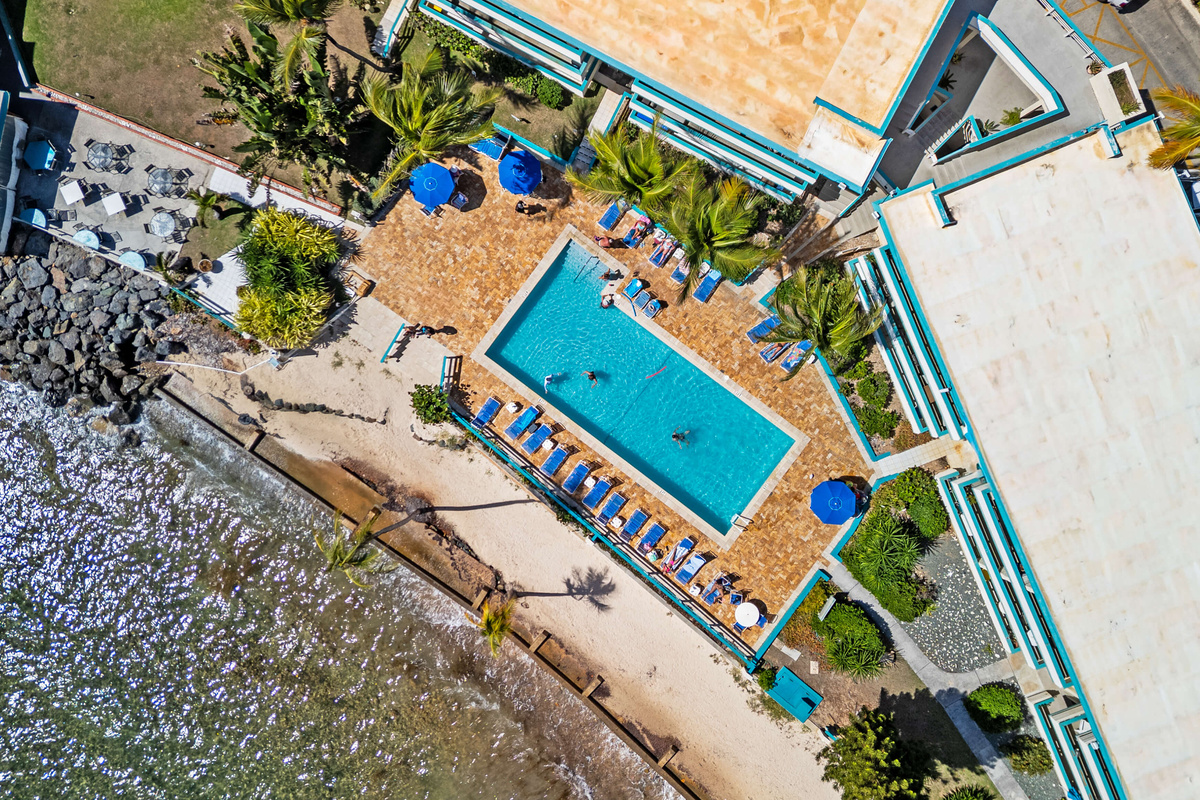 Aerial view of the resort pool surrounded by tropical beauty.