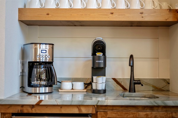 Enjoy a complete coffee setup—drip brewer, Keurig, mugs, and sink—perfect for easy mornings during your Broken Bow stay. 🌲☕