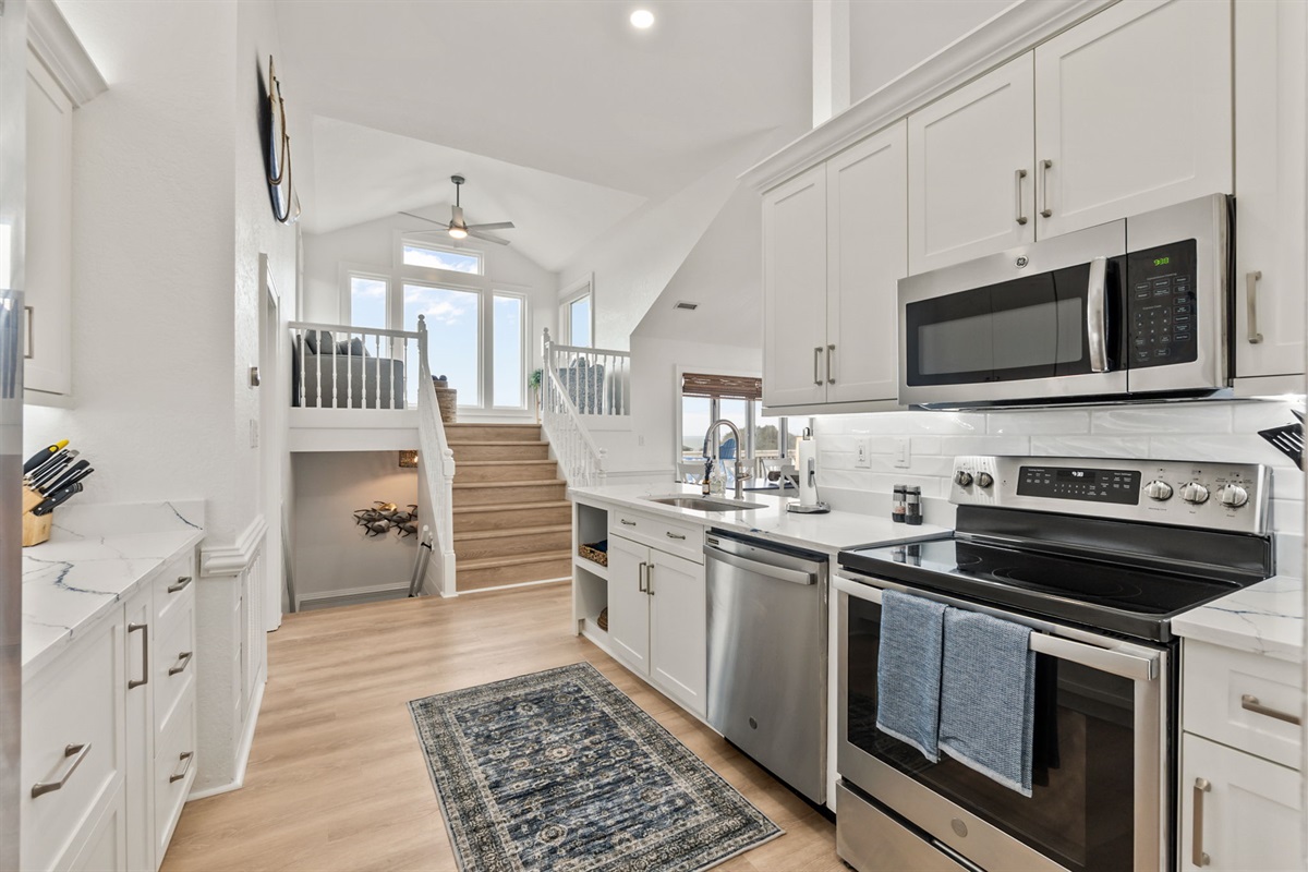 Bright, open kitchen with stainless steel appliances and plenty of room to cook, gather, and hang out.