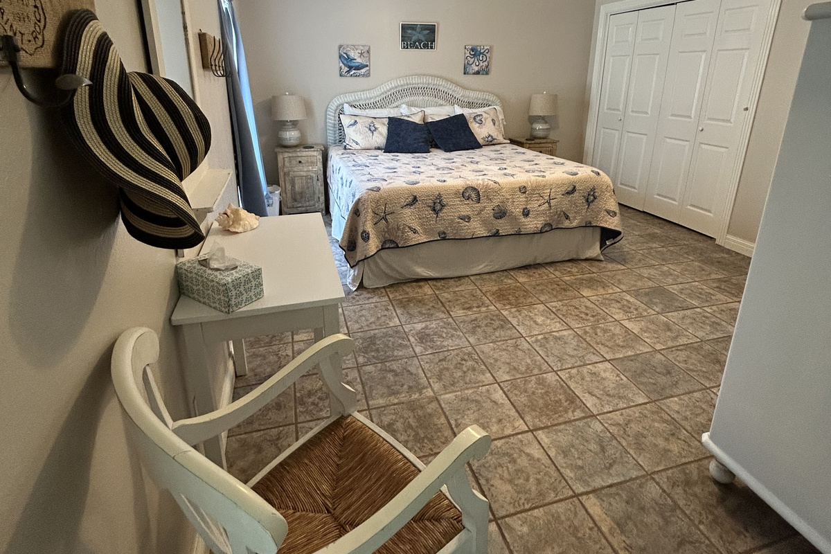 King Suite with ensuite bathroom and direct pool/backyard access (ground level). Includes a large closet with plenty of storage space for luggage, clothing, and beach essentials.