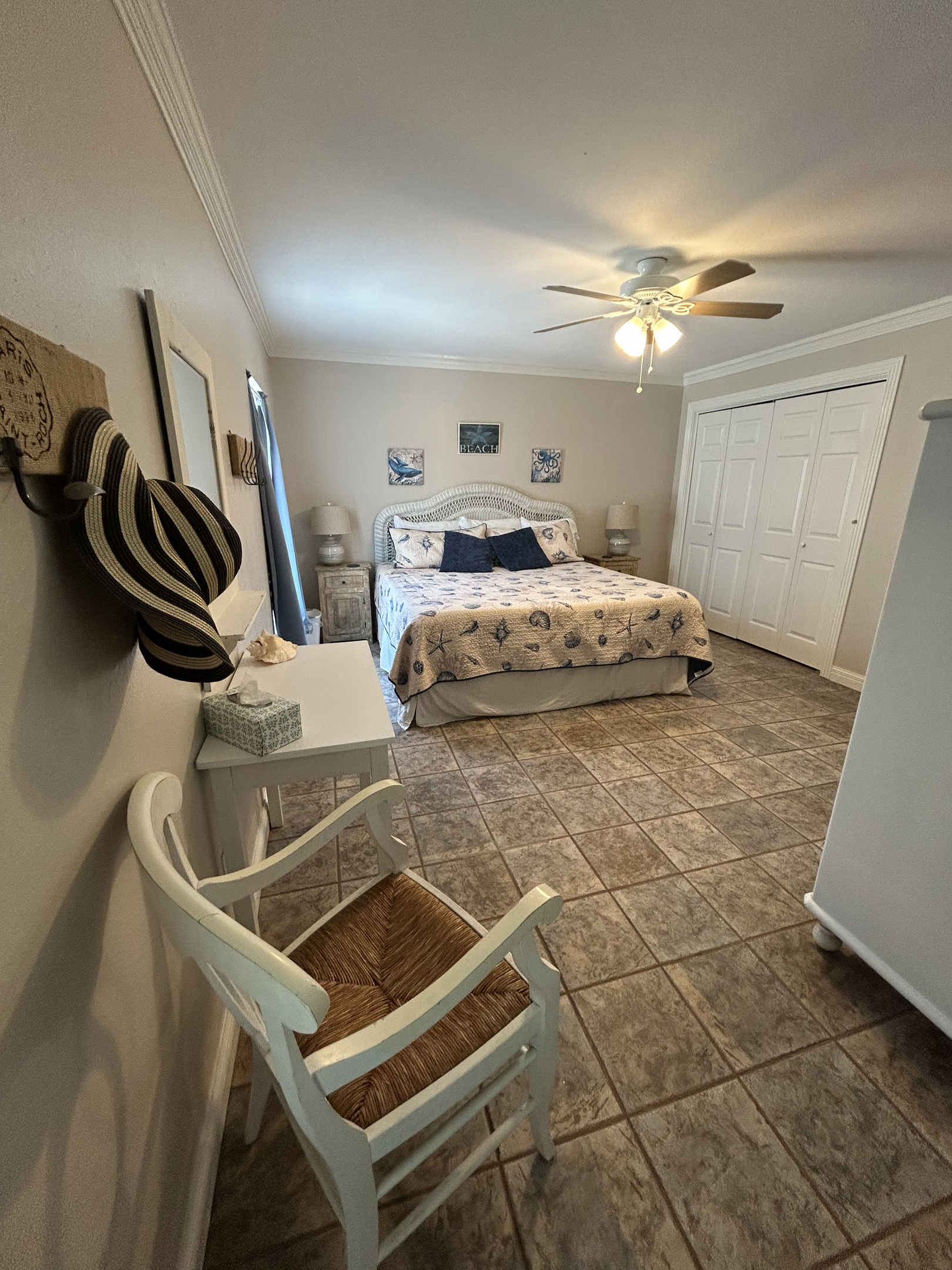 King Suite with ensuite bathroom and direct pool/backyard access (ground level). Includes a large closet with plenty of storage space for luggage, clothing, and beach essentials.