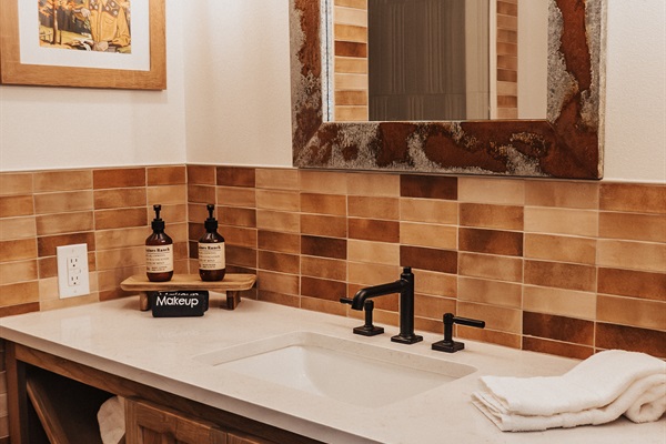 Private en-suite Bathroom #2 at Cutter's Quarters &mdash; a designer vanity in warm Hill Country tile, paired with the second king bedroom.