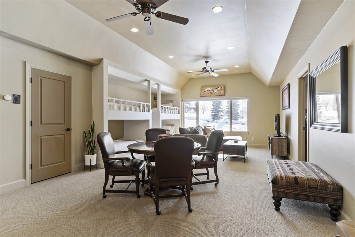 A spacious lower-level gathering area with seating and dining space—perfect for games, conversation, or extra room to spread out.