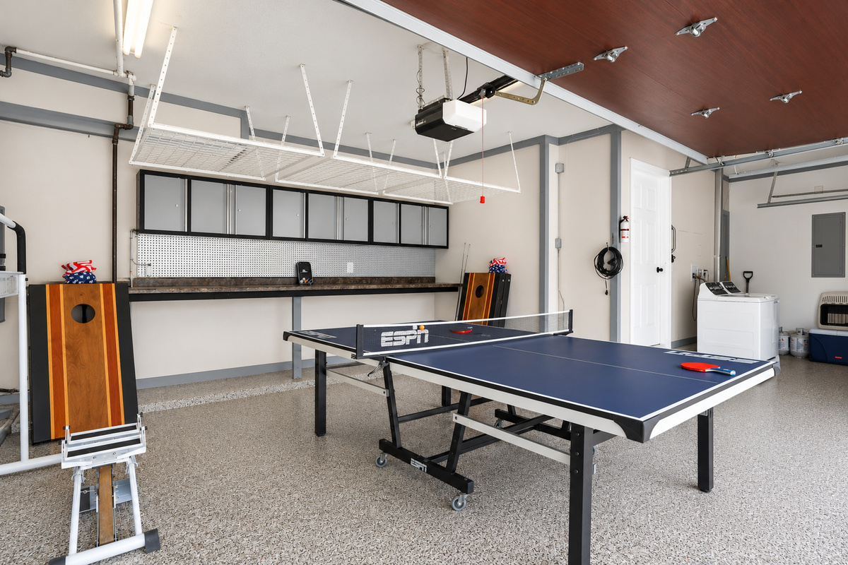Spacious garage game area with ping pong table and open layout, perfect for recreation, entertainment, and casual group fun.