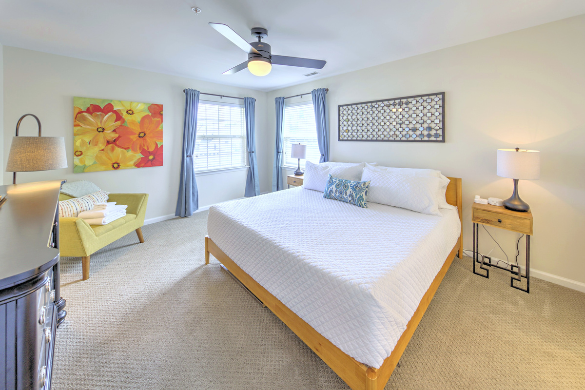 Fresh linens provided and beds professionally made before arrival—no linen rentals required.

Primary Bedroom: Bright and airy retreat with a king bed and cheerful decor! Perfect for relaxation.