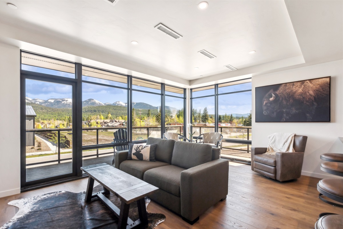 Expansive windows invite natural light and majestic mountain vistas! Enjoy every moment.