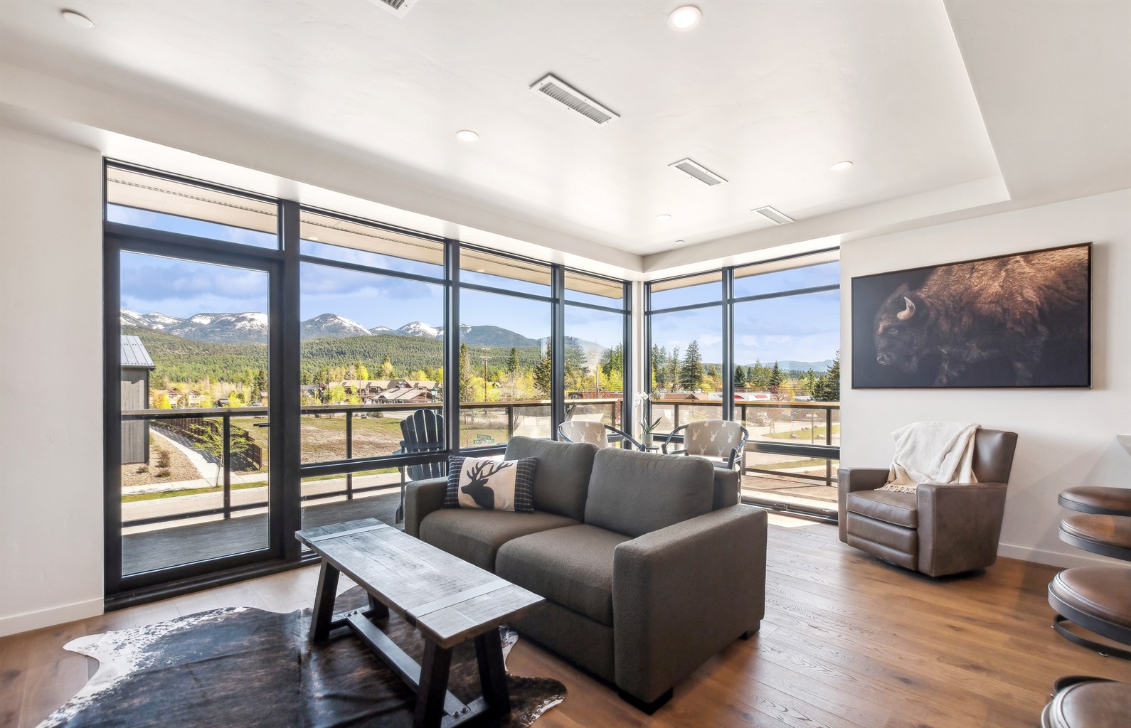 Expansive windows invite natural light and majestic mountain vistas! Enjoy every moment.