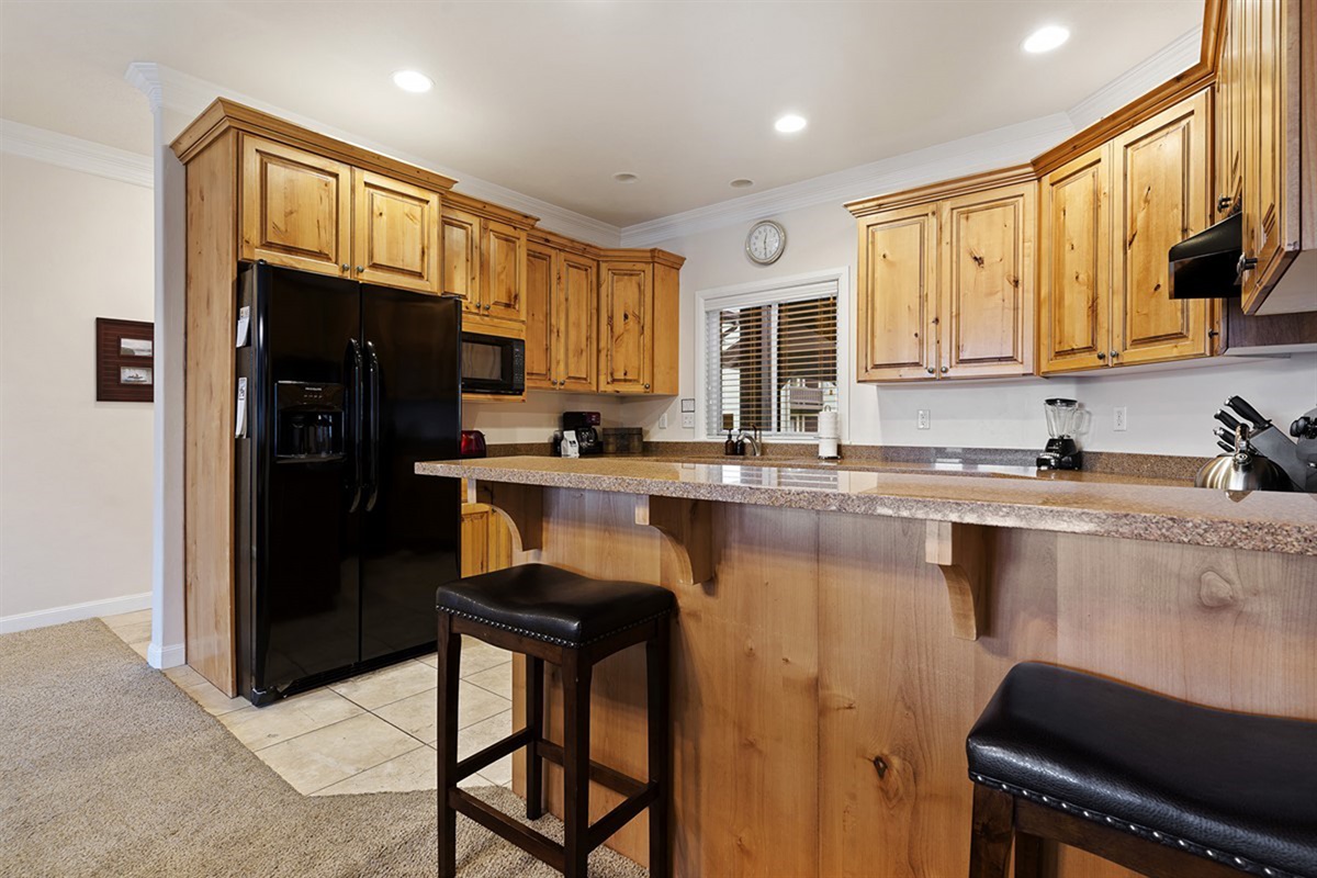 Spacious layout with bar seating for two—perfect for casual meals or morning coffee.