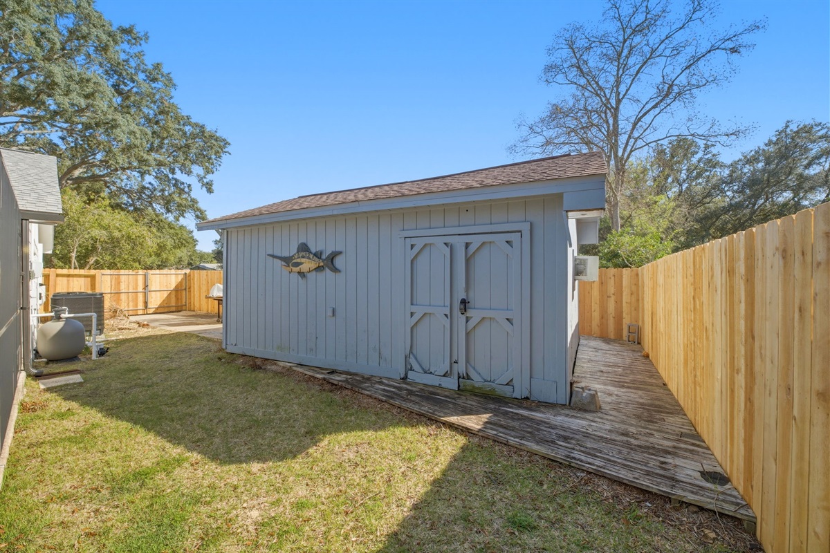 The backyard features a convenient storage shed perfect for tools, outdoor gear, or hobby space. Surrounded by a fenced yard, this area offers privacy and functionality while still leaving room to enjoy the outdoor space.