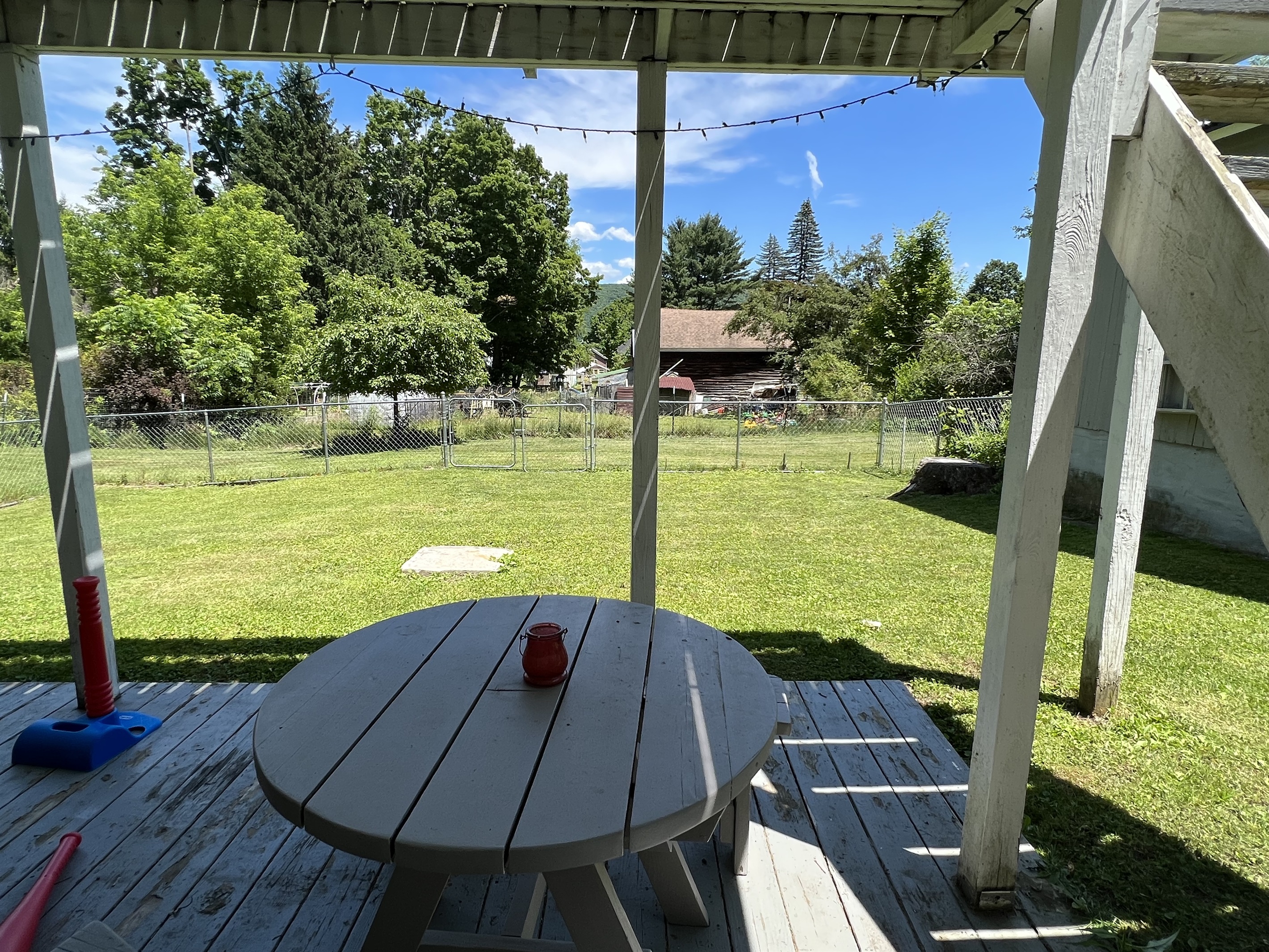Partially covered patio under screened porch