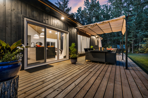 Step onto the expansive front deck for morning coffee, outdoor meals, or quiet evenings surrounded by trees.