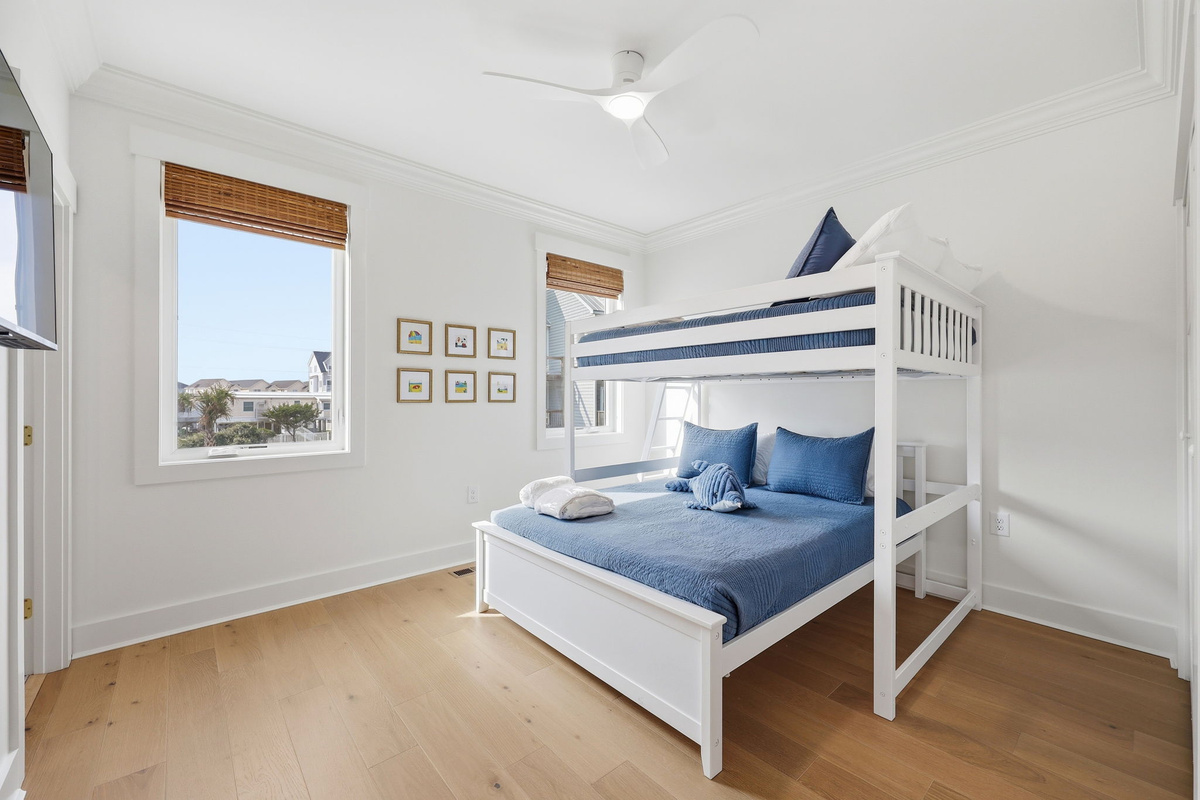 First-floor bunk room featuring full-over-queen bunk bed and coastal light-filled design