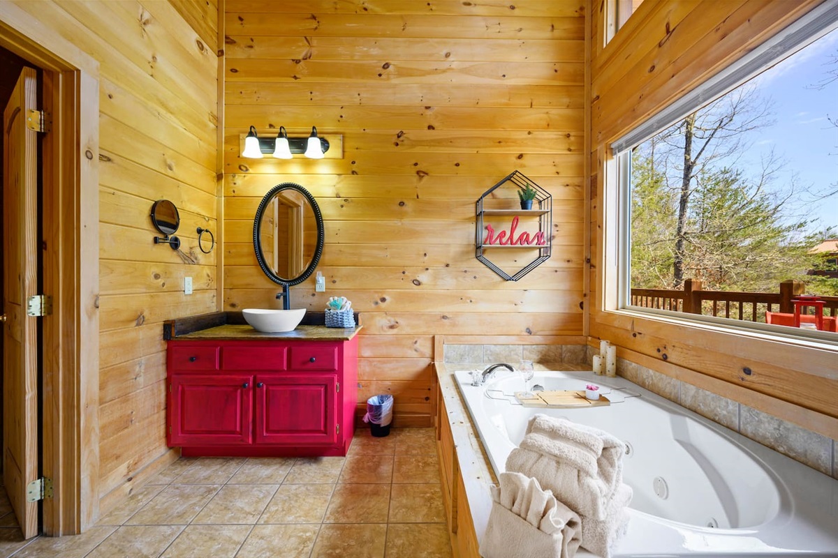 Ensuite bathroom with sink and garden tub.