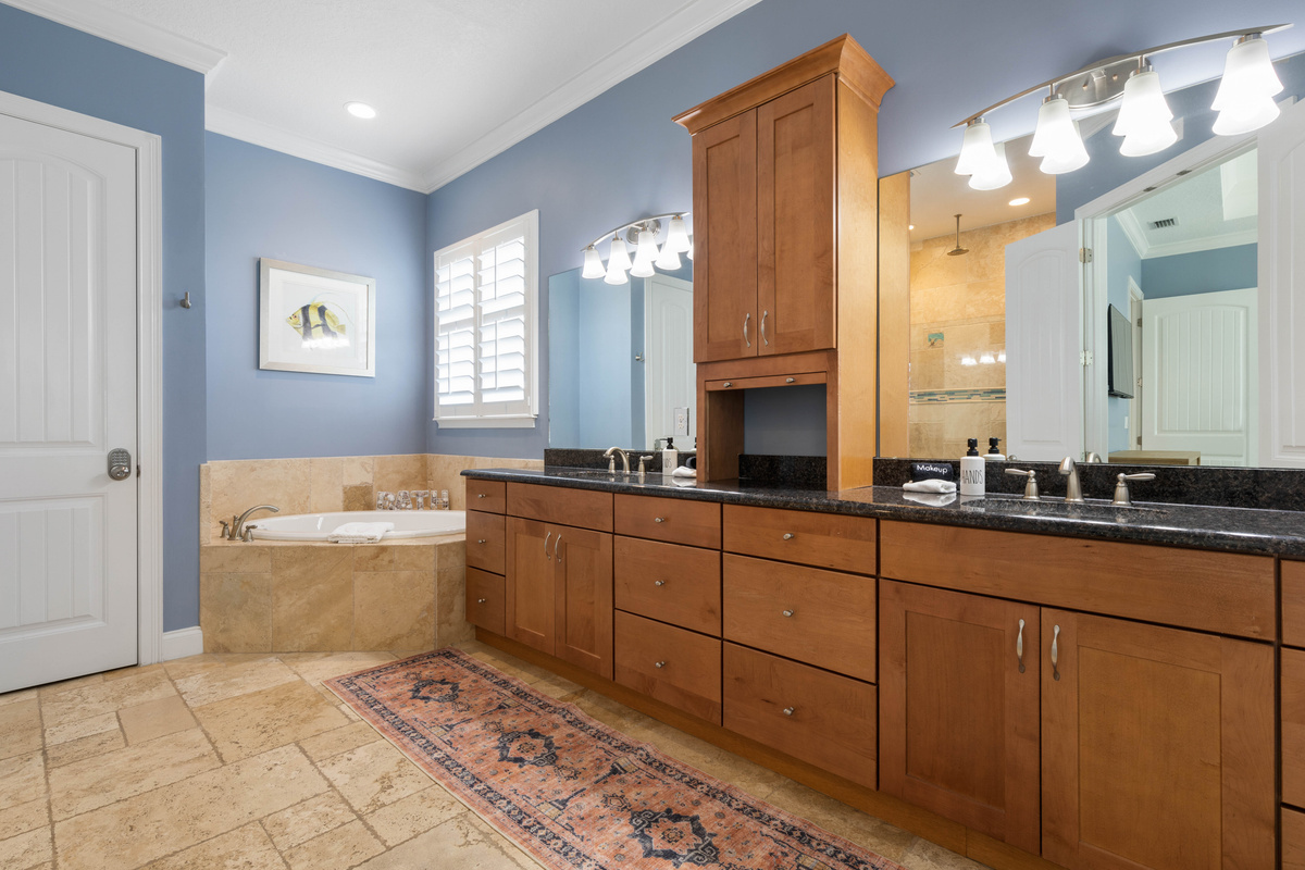 Primary bath with a long double vanity, plenty of drawers and a corner soaker tub, so getting ready never feels rushed.
