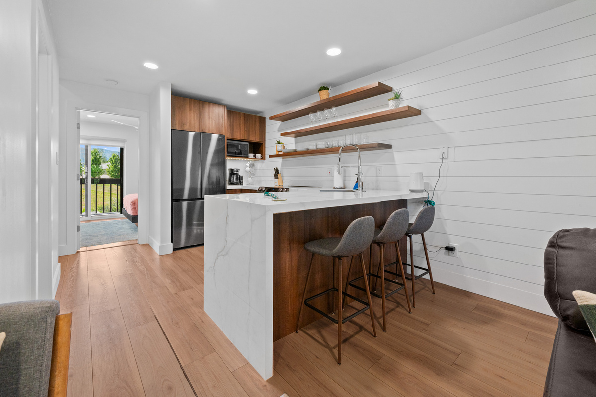 Modern kitchen with breakfast bar seating for three and an open, spacious layout.
