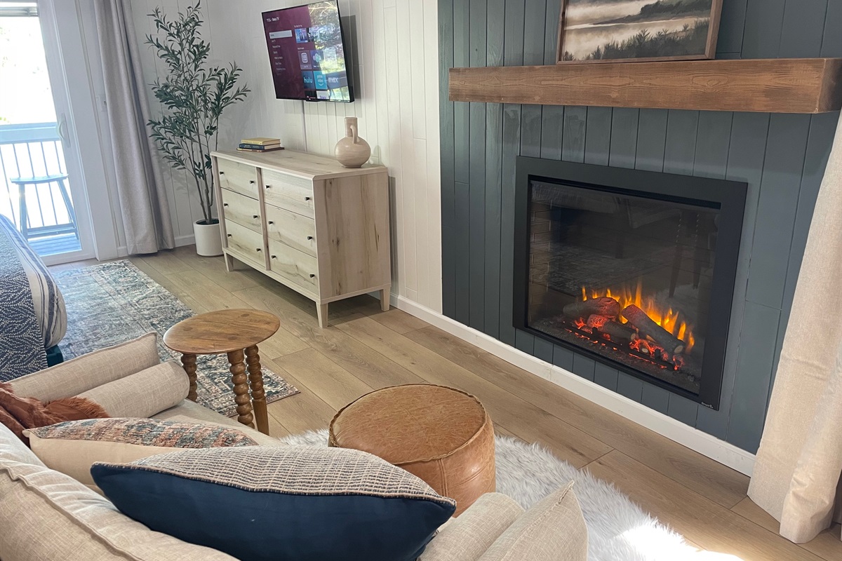 Curl up with a book on the couch in front of the electric fireplace