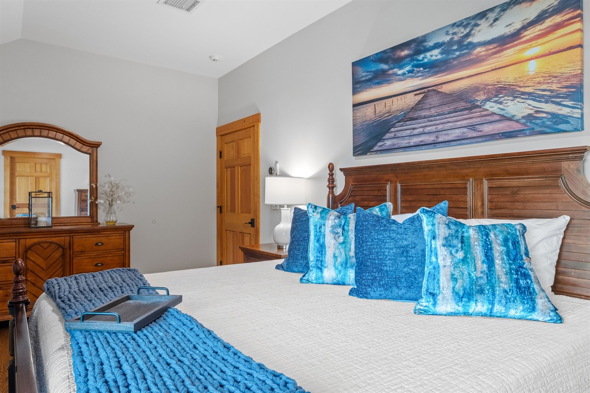 Second floor ensuite bedroom with king bed, balcony overlooking lake and its own full bath