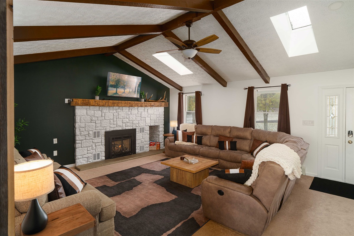 Warm, Stylish Living Room with Gas Fireplace & Skylights. Comfort meets charm in this beautifully designed farmhouse gathering space.