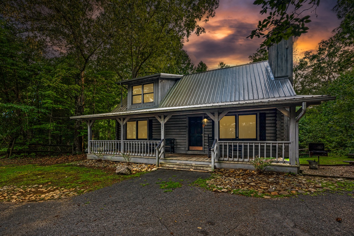 Your mountain retreat: cozy cabin, inviting porch for relaxation.