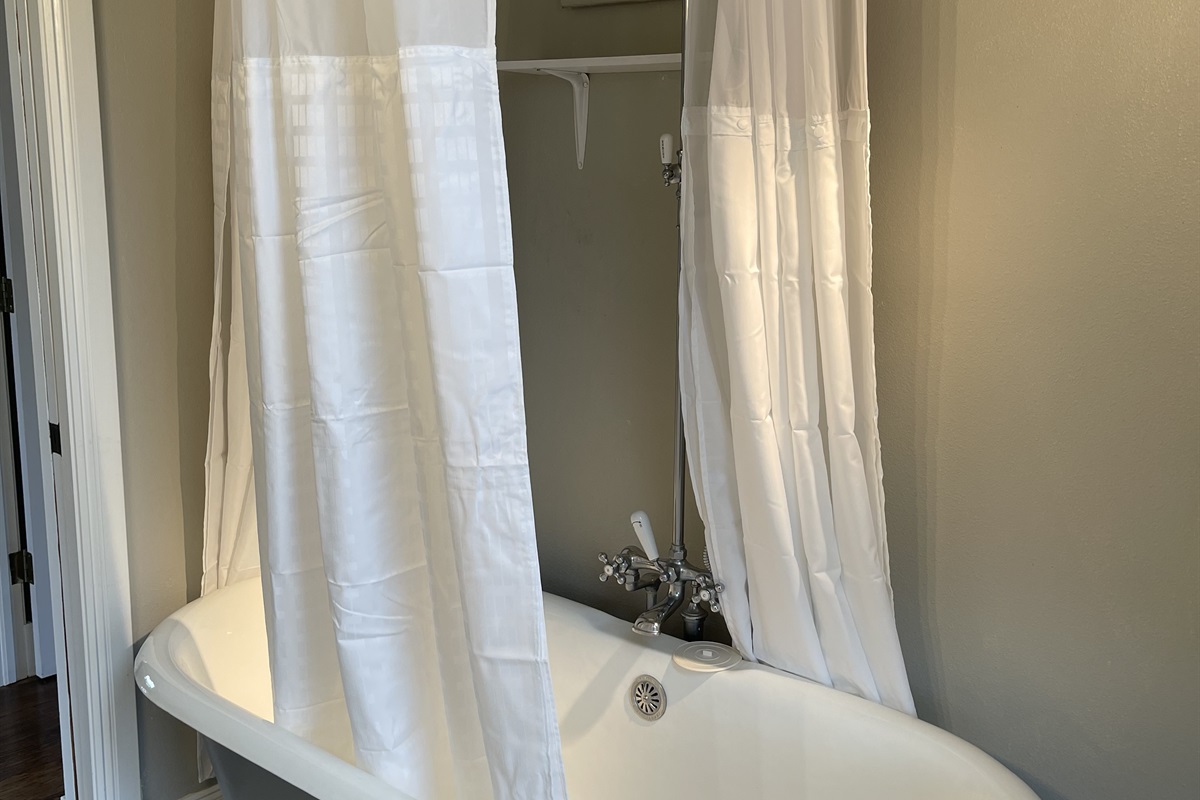 Clawfoot tub and shower in bathroom on second level