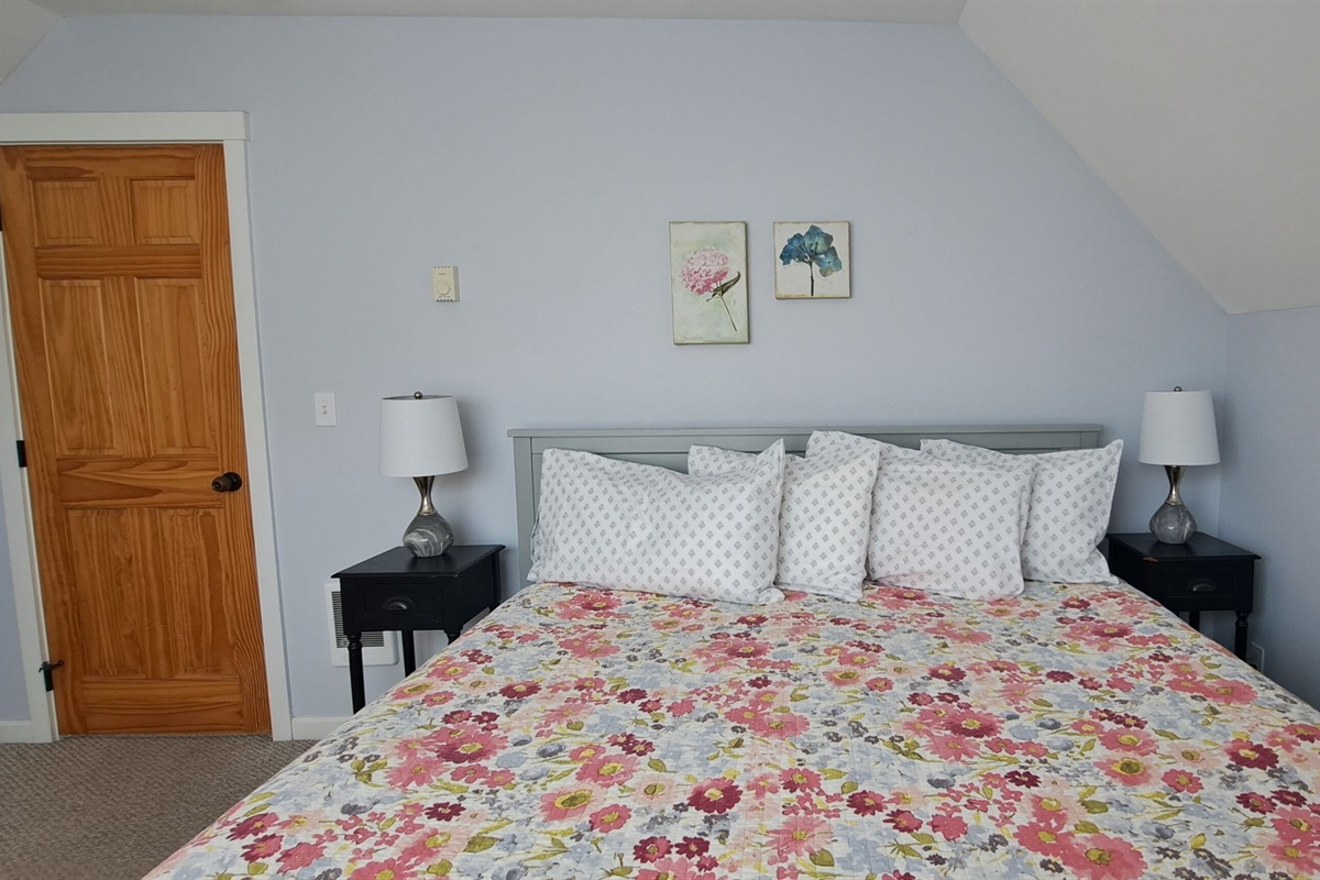 Soft pastel accents complete the king bedroom, offering a peaceful and inviting space to unwind after a day at the beach.