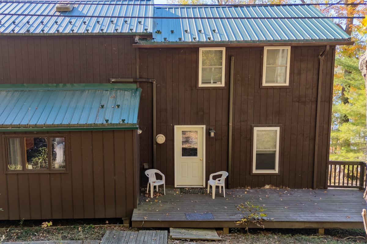 Rear exterior showing large vertical windows and deck access from main floor.
