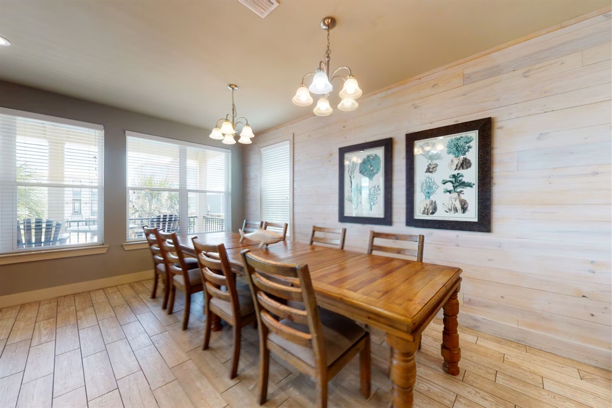 Dining area with a table and chairs set for 8 and additional seating for 4 at the breakfast bar 