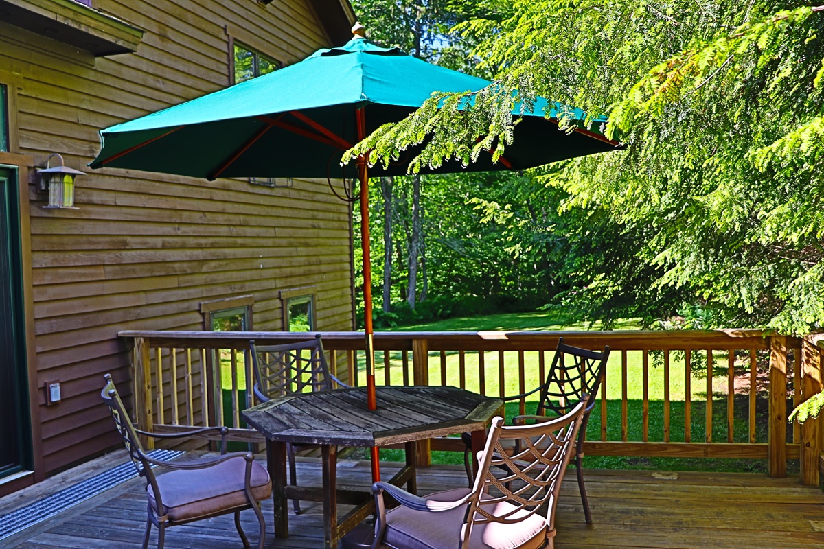 Outdoor dining with a view of the large backyard.