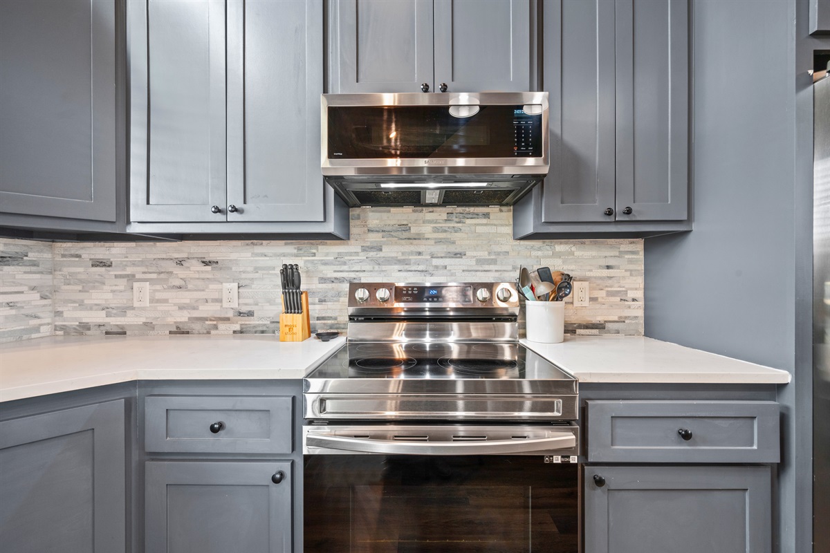 Cooking is a breeze in this sleek kitchen setup, featuring a modern stove and plenty of room to make everything from pancakes to pasta.