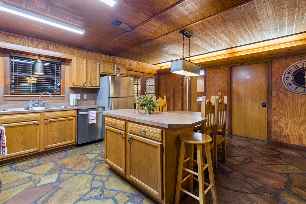Spacious kitchen with island and bar seating.