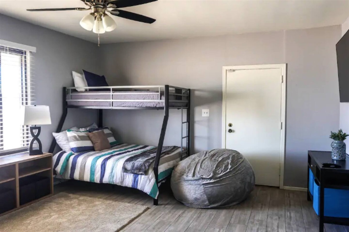 Bunk room offers TV and bean bag chars.