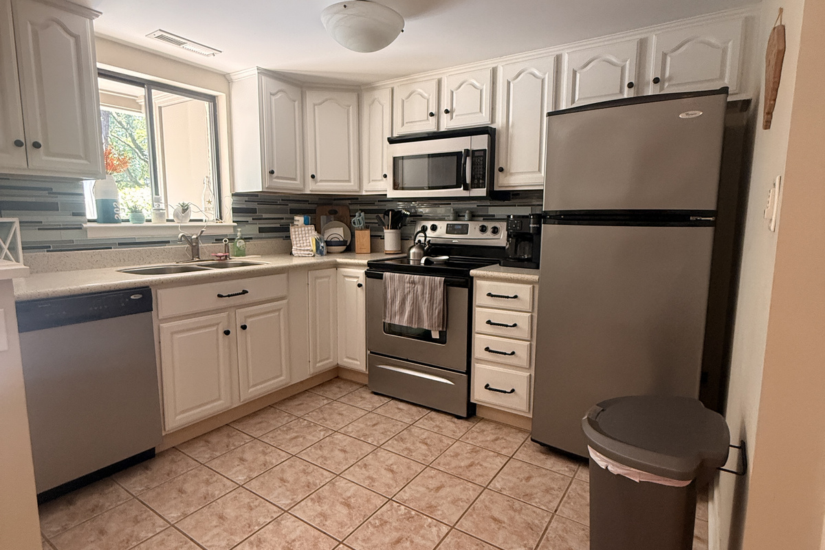 Fully equipped kitchen with white cabinets