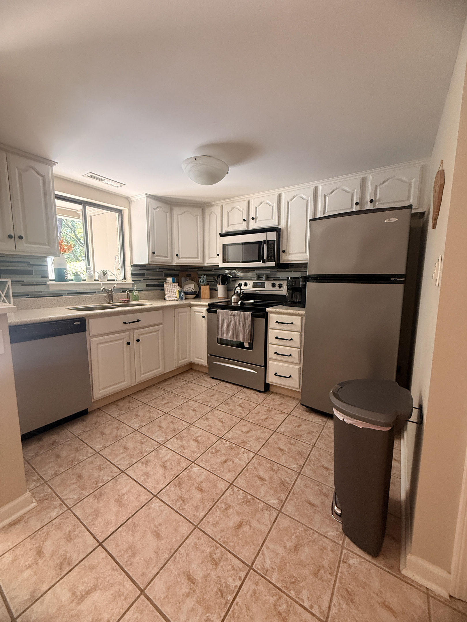 Fully equipped kitchen with white cabinets