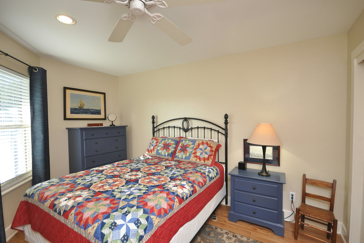Secondary bedroom with chest of drawers and nightstand for clothes, etc.
