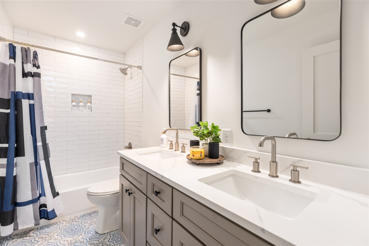 Full bathroom with tub/shower and two sinks